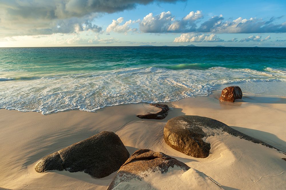 Surf surging towards boulders buried in sand on a tropical beach Anse Victorin Beach-Seychelles art print by Sergio Pitamitz for $57.95 CAD