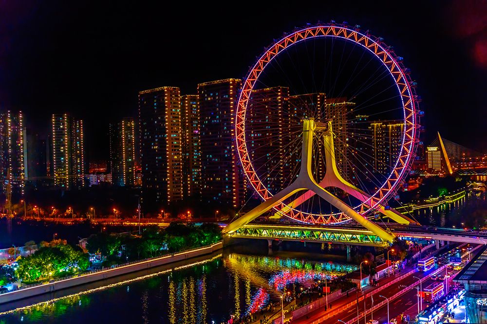 Colorful large ferris wheel over Yongle Bridge, Tianjin, China. Built in 2007. art print by William Perry for $57.95 CAD