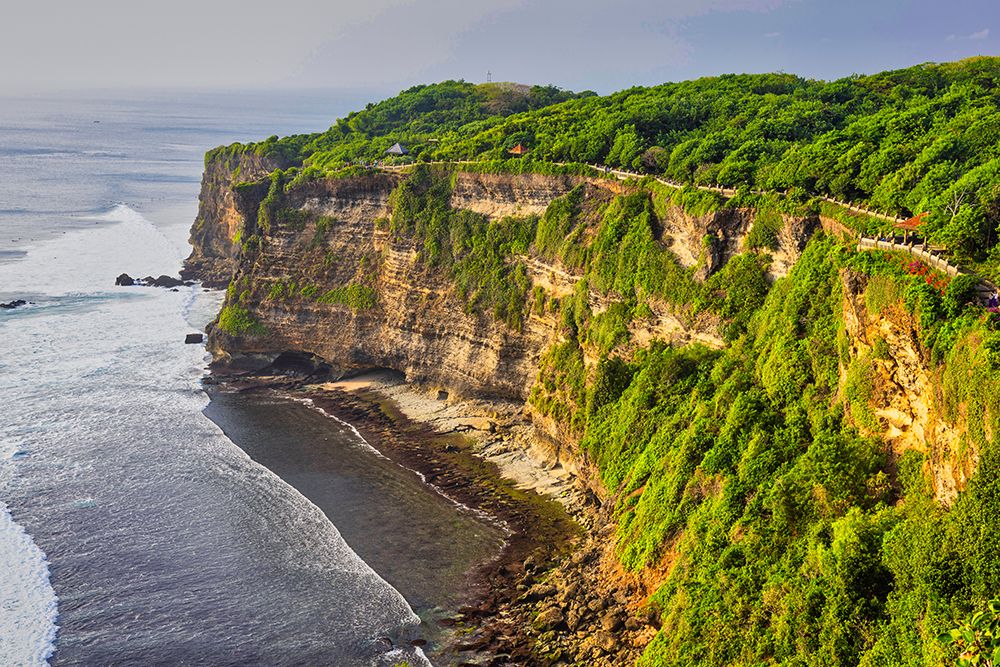 Uluwatu Temple is one of Balis most important spiritual sites, dedicated to the spirits of the sea art print by Greg Johnston for $57.95 CAD