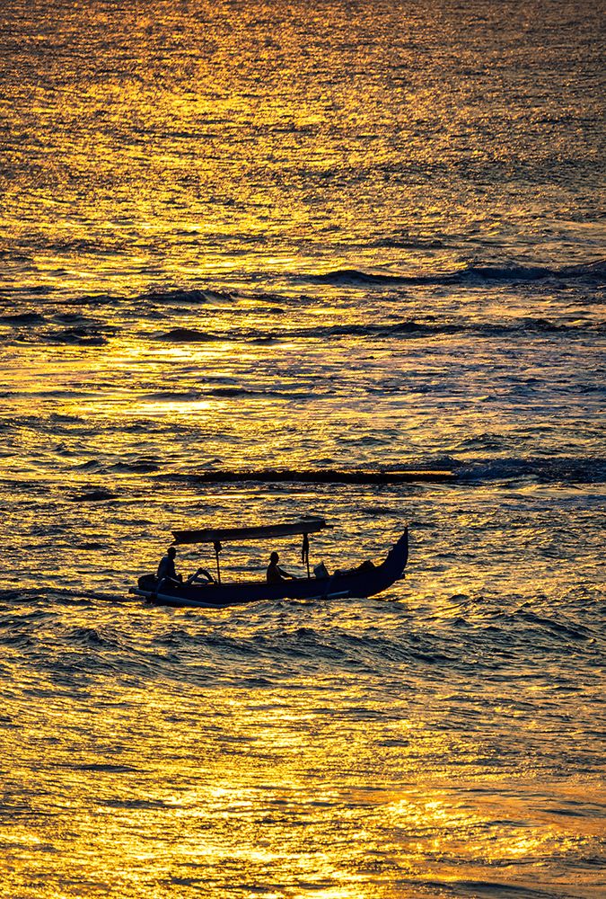 Fishing boat returning to shore in a blaze of gold sunset light in Bali, Indonesia art print by Greg Johnston for $57.95 CAD