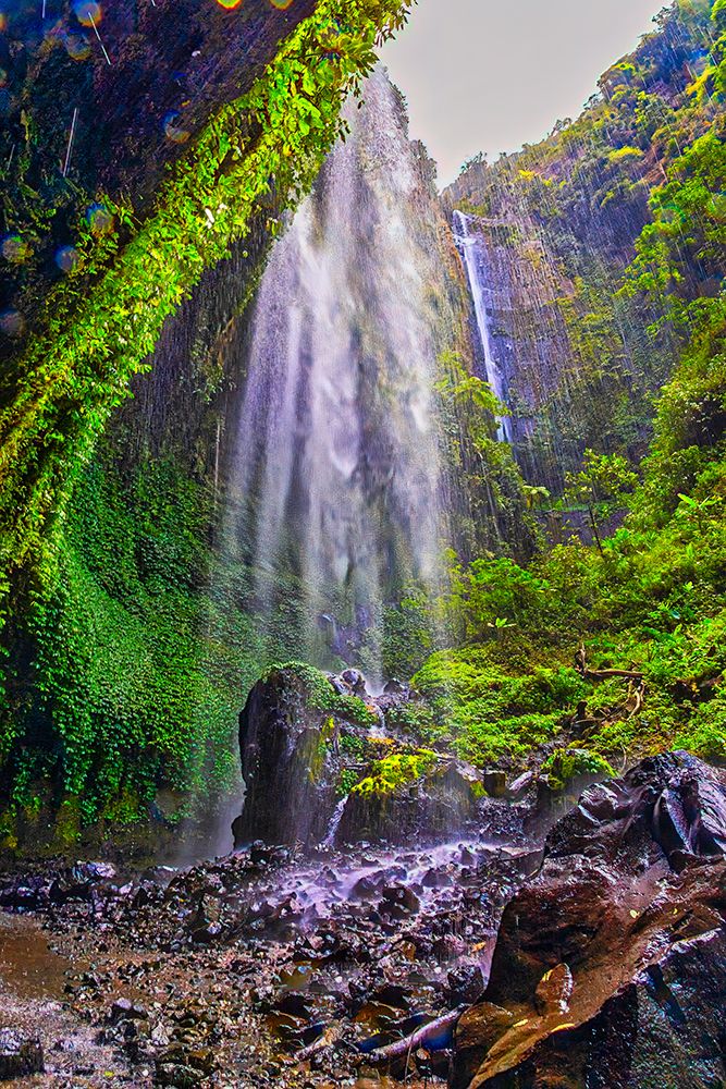 Indonesia. Tumpak Sewu waterfall flowing into a turquoise pool below. It is located near Lumajang. art print by Greg Johnston for $57.95 CAD