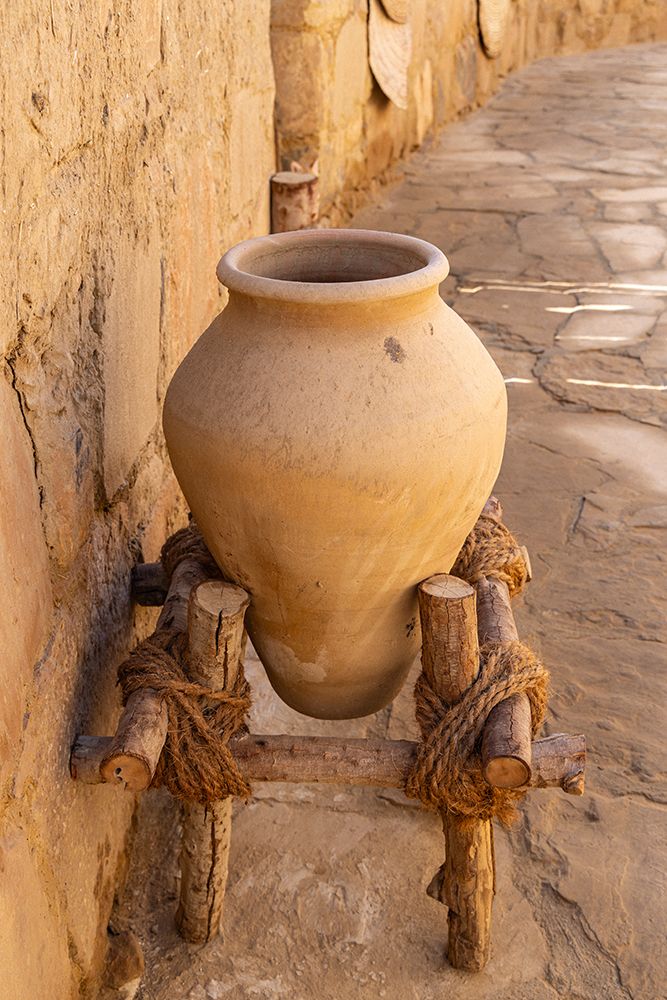 Saudi Arabia, Tabuk Province, Tayma. An amphora on a stand at a desert oasis. art print by Emily M. Wilson for $57.95 CAD