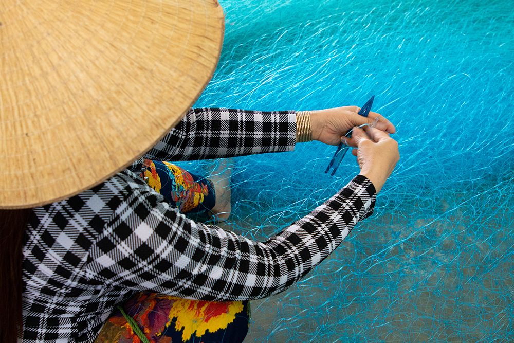 Vietnam-Women repairing fishing nets art print by Tom Norring for $57.95 CAD