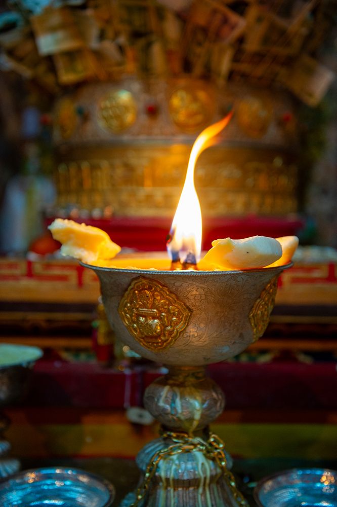Tibet, Kham, Litang. A candle burns at the altar of a Litang Monastery. art print by Alison Wright for $57.95 CAD