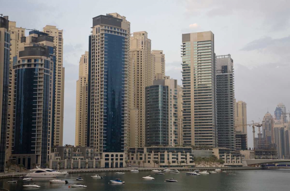 UAE, Dubai Modern buildings tower over boats art print by Bill Young for $57.95 CAD