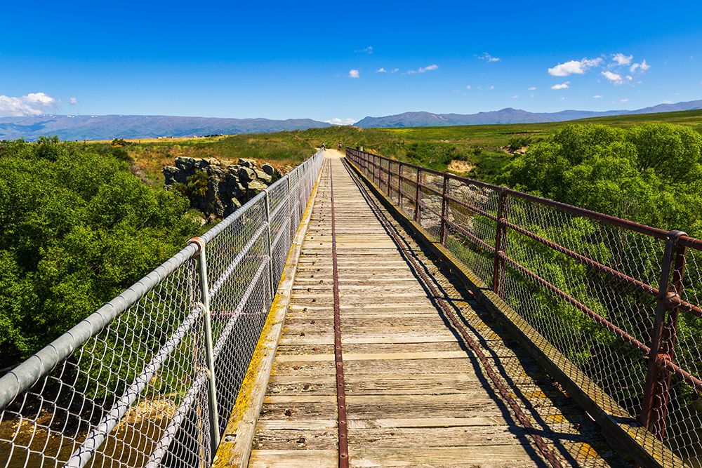 The Manuherikia River bridge on the Otago Central Rail Trail-Otago-South Island-New Zealand art print by Russ Bishop for $57.95 CAD