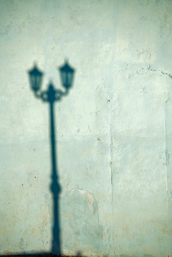 Morning shadow of a lamppost on light blue-green house wall in Trinidad-Cuba art print by Janis Miglavs for $57.95 CAD