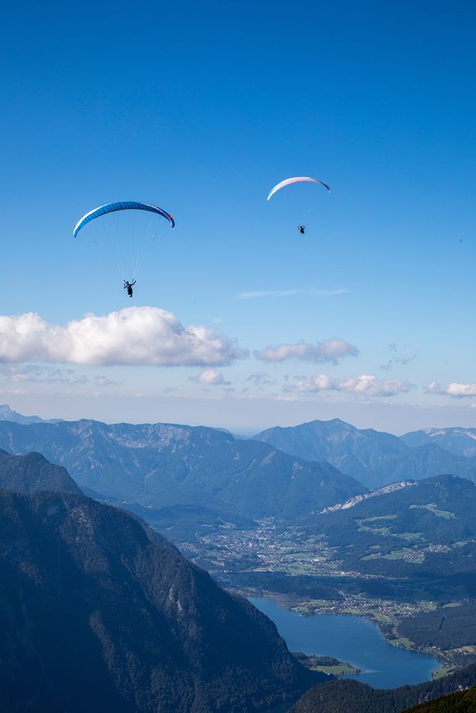 Austria-Dachstein-Paragliders as they soar above Lake Hallstatt and the surrounding mountains art print by Hollice Looney for $57.95 CAD