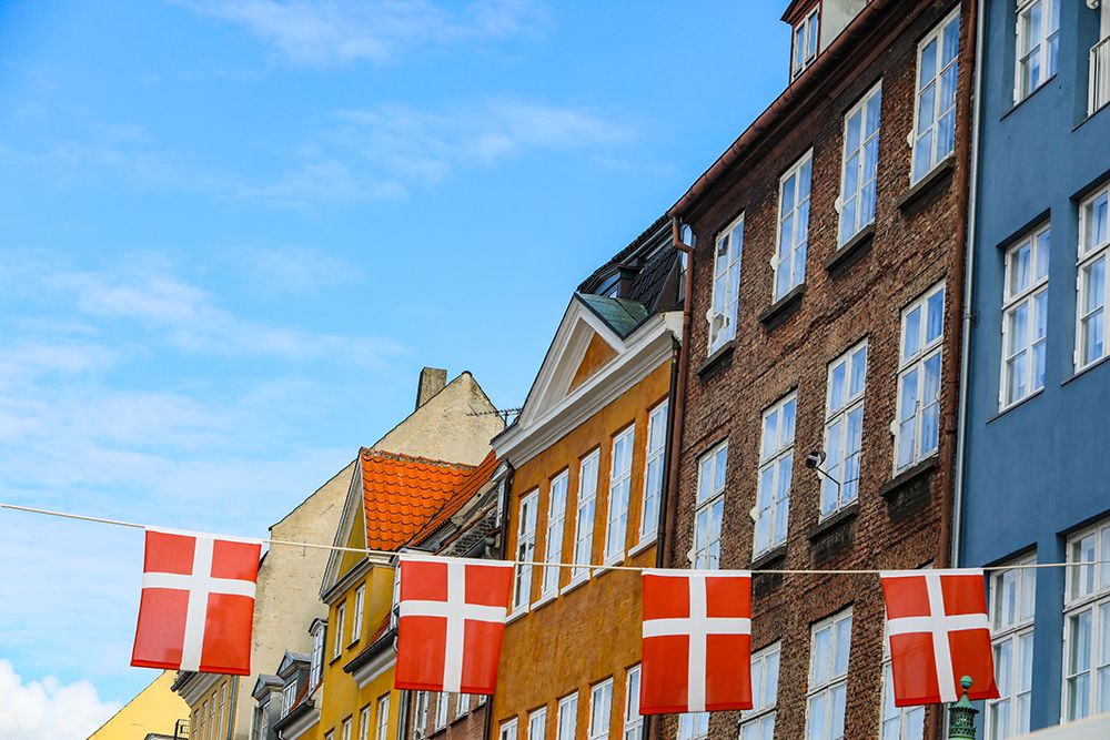 Copenhagen, Denmark. Nyhavn area, colorful painted houses, Denmark flag. art print by Jolly Sienda for $57.95 CAD