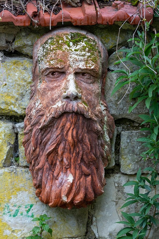 France-Giverny Stone face hanging on a stone wall art print by Jaynes Gallery for $57.95 CAD