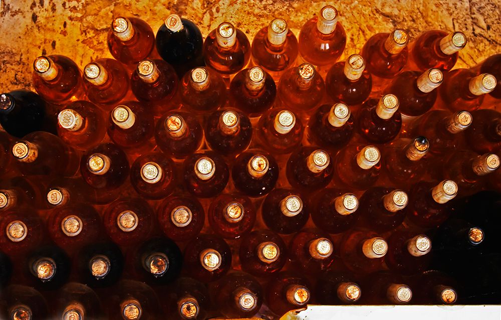 Bottles of sauternes stacked high art print by Per Karlsson for $57.95 CAD