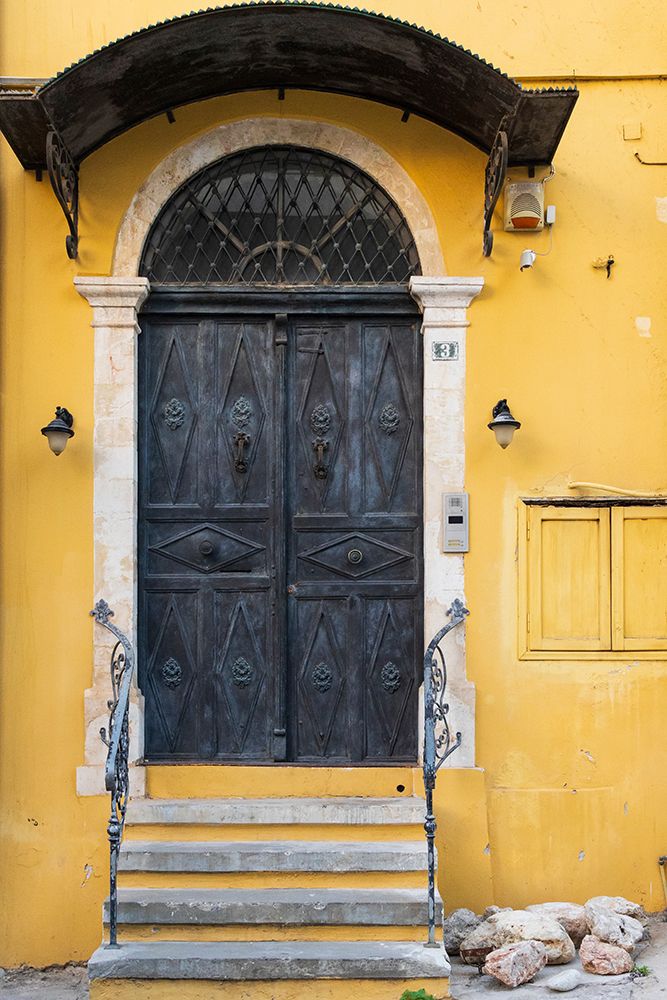 Greece, Crete, Chania, Old Town. Black double doorway in yellow wall. art print by Emily M. Wilson for $57.95 CAD