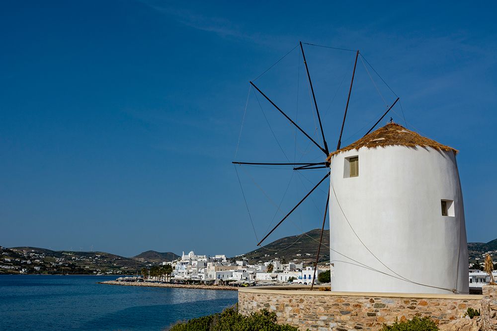 A scenic view of the Parikia waterfront and a traditional windmill Cyclades Islands-Greece art print by Sergio Pitamitz for $57.95 CAD