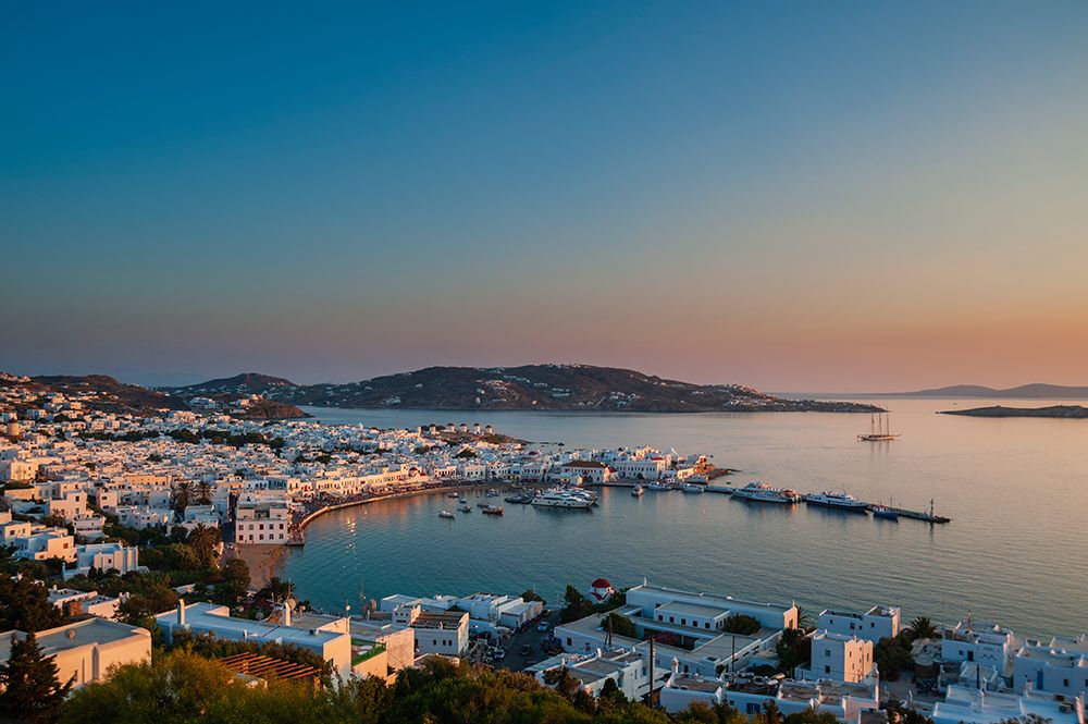 Scenic view of Chora and the nearby sea at sunset Chora-Mykonos Island-Cyclades Islands-Greece art print by Sergio Pitamitz for $57.95 CAD