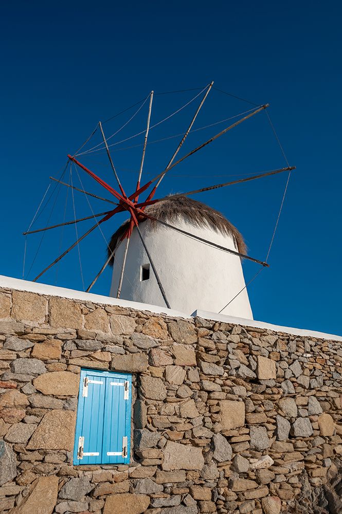 A traditional windmill set behind a rock masonry wall Chora-Mykonos Island-Greece art print by Sergio Pitamitz for $57.95 CAD