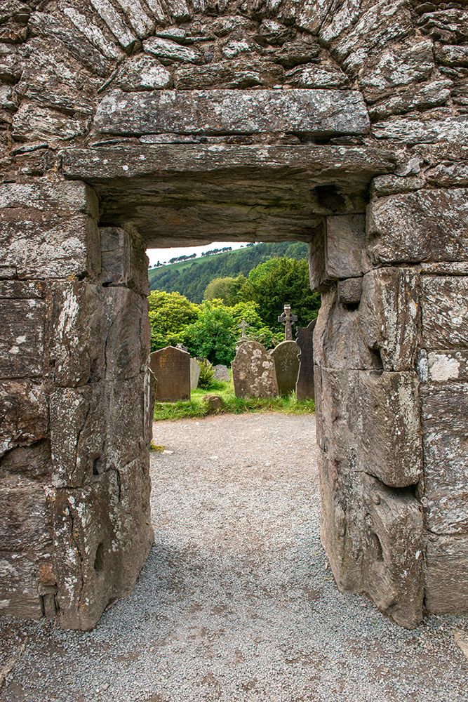 Ancient door marks the passageway between the old church and graveyard at Glendalough Monastery. art print by Betty Sederquist for $57.95 CAD