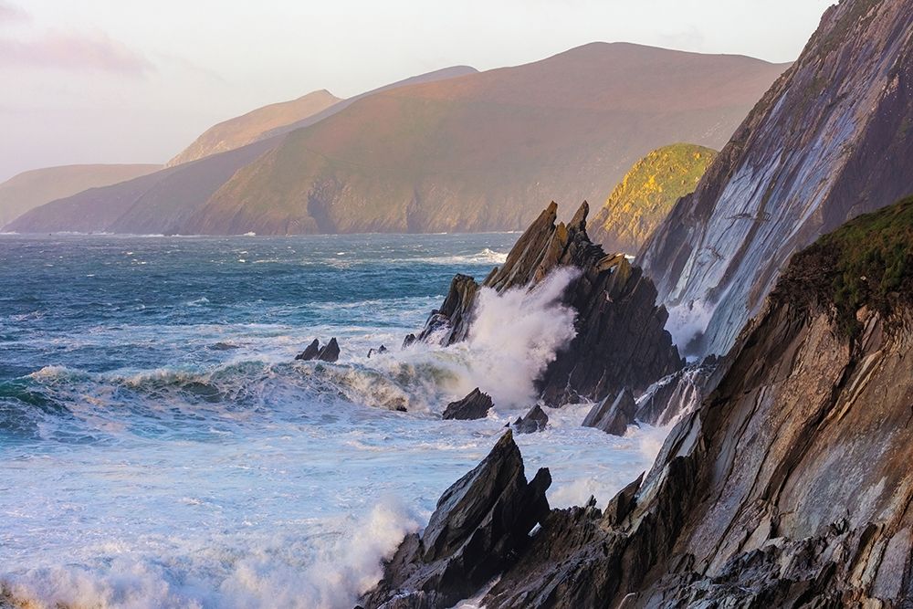 Waves crash into cliffs on Dunmore Head with Blasket Islands on the Dingle Peninsula-Ireland art print by Chuck Haney for $57.95 CAD