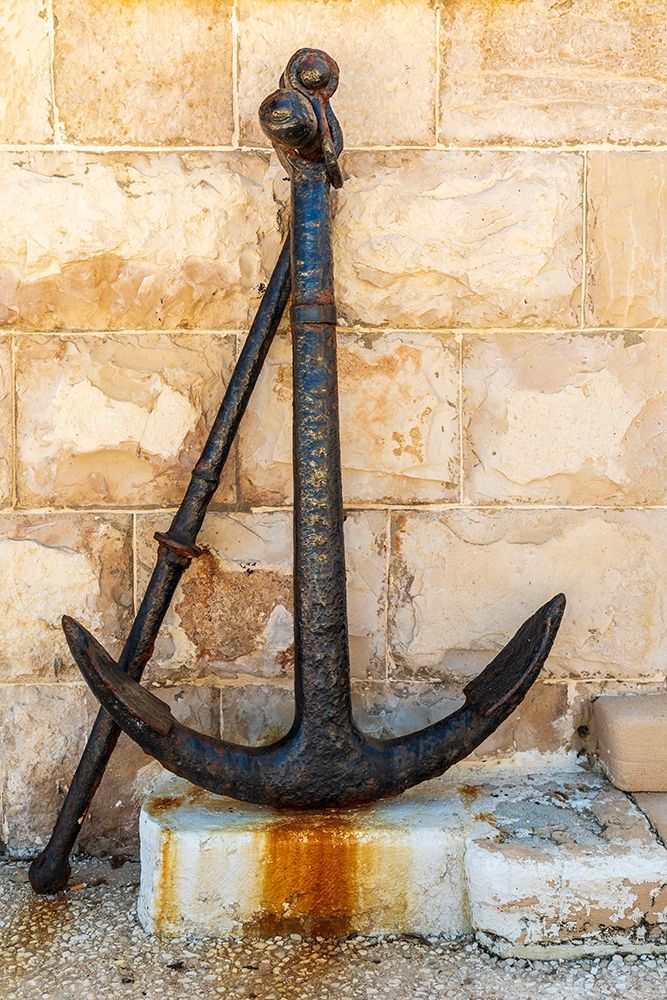 Italy-Apulia-Metropolitan City of Bari-Giovinazzo Old rusted anchor in front of a stone wall art print by Emily Wilson for $57.95 CAD