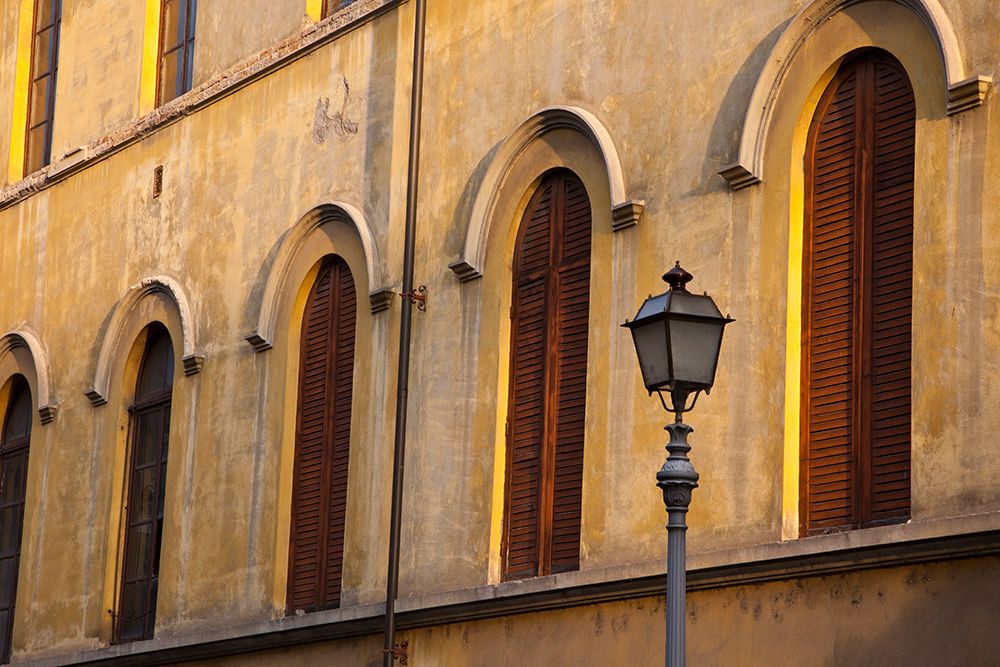Italy-Tuscany-Lucca Street lamppost and arched windows with wooden shutters art print by Julie Eggers for $57.95 CAD