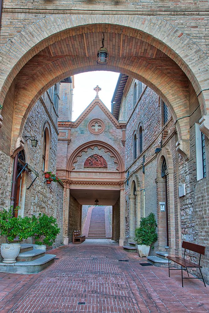 Italy- Umbria- Assisi. Archway and path leading to the Monastero della Santa Croce Catholic Church. art print by Julie Eggers for $57.95 CAD