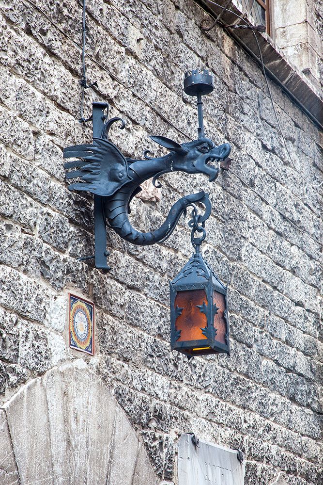 Italy- Umbria- Assisi. Old stone wall with Dragon Lantern. art print by Julie Eggers for $57.95 CAD
