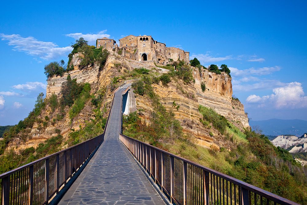 Italy- Tuscany. Evening view of Civita di Bagnoregio and the long bridge leading to town. art print by Julie Eggers for $57.95 CAD