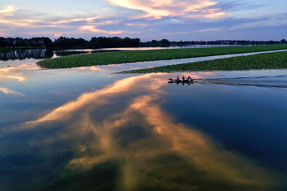 Italy-Mantova (Mantua) Sunset reflection and boat on lake art print by Michele Molinari for $57.95 CAD
