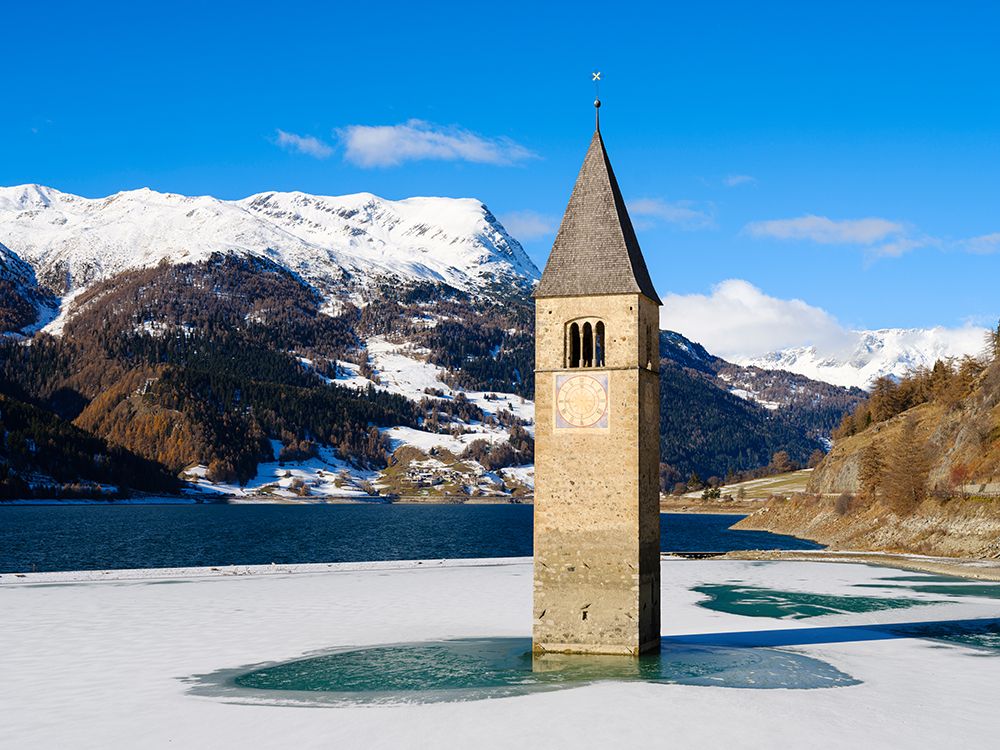 The steeple of village Alt-Graun in Lake Reschensee, Val Venosta. Italy, Sudtirol, Alto Adige. art print by Martin Zwick for $57.95 CAD