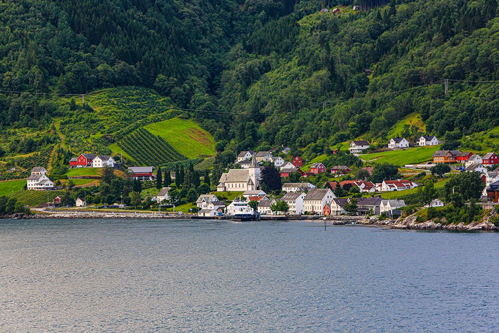 Norway, Norwegian Fjords. Seaside village, church, red barns art print by Jolly Sienda for $57.95 CAD