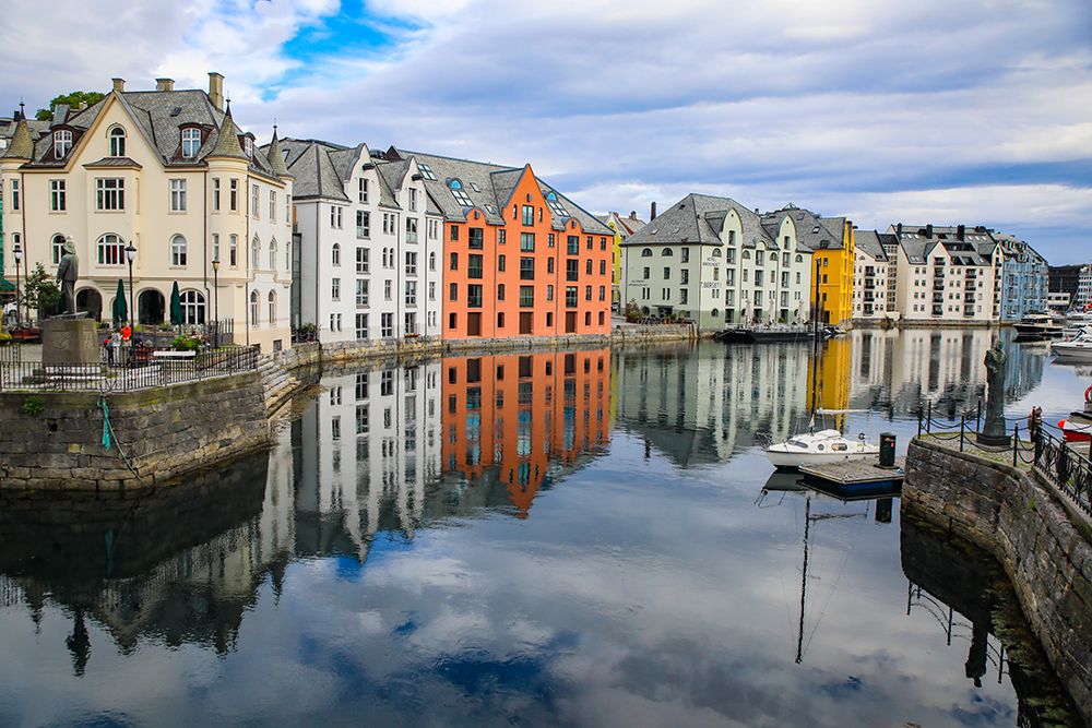 Alesund, Norway. Canal with colorful painted houses, boats, marina, sailor statue. art print by Jolly Sienda for $57.95 CAD