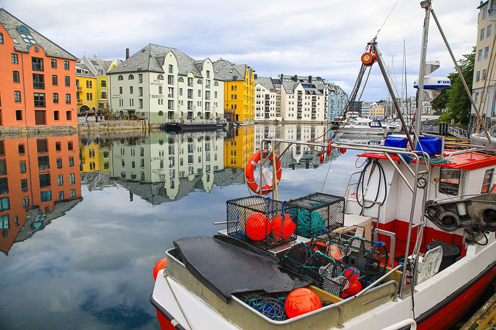 Alesund, Norway. Fishing boat and canal water reflection. art print by Jolly Sienda for $57.95 CAD