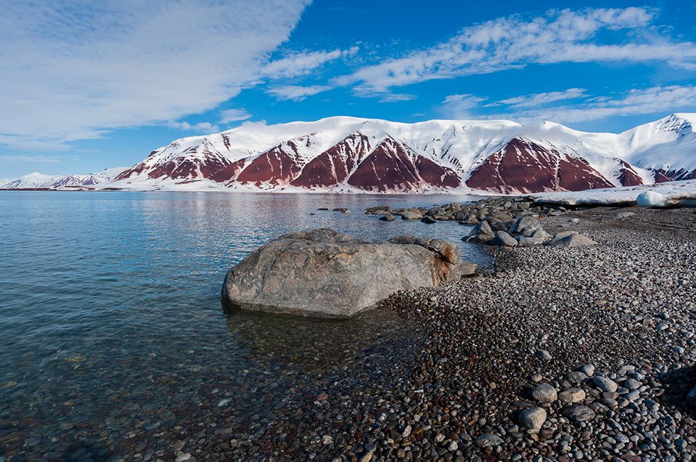 A gravel shoreline and snow covered mountains border Bockfjorden-Spitsbergen Island-Norway art print by Sergio Pitamitz for $57.95 CAD
