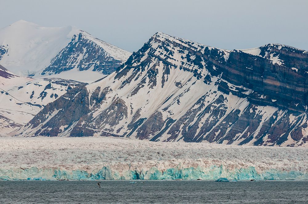 Ice capped mountains and a glacier border Kongsfjorden near Ny-Alesund-Spitsbergen Island-Norway art print by Sergio Pitamitz for $57.95 CAD