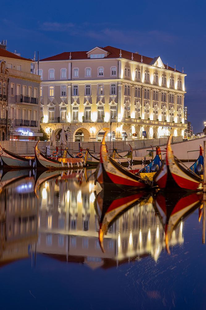 Gondola style fishing tour boats in canal in Aveiro, Portugal art print by Chuck Haney for $57.95 CAD