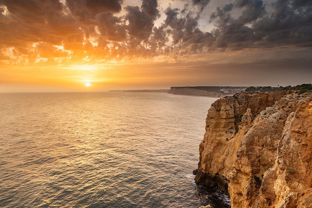 Dramatic sunset clouds over Cliffs along the coast at Ponta da Piedade in Lagos-Portugal art print by Chuck Haney for $57.95 CAD