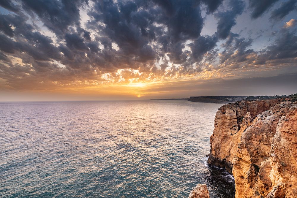 Dramatic sunset clouds over Cliffs along the coast at Ponta da Piedade in Lagos-Portugal art print by Chuck Haney for $57.95 CAD