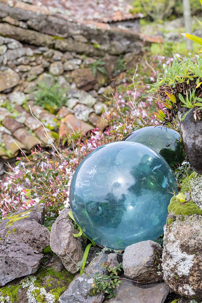 Aldeia da Cuada, Azores, Portugal. Glass fishing net floats in a garden on Flores Island. art print by Emily M. Wilson for $57.95 CAD