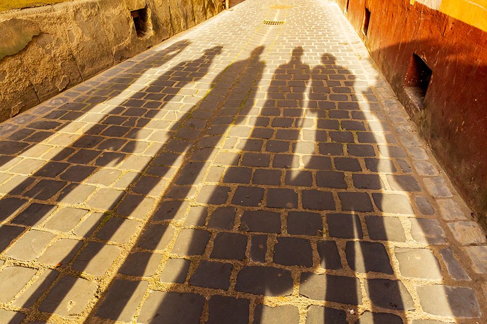 Romania-Brasov Shadowed figures in silhouette on street cobblestone art print by Emily M. Wilson for $57.95 CAD