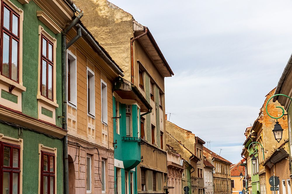Romania Brasov. 16th century arcaded, and terra cotta roofed houses and narrow streets. art print by Emily M. Wilson for $57.95 CAD