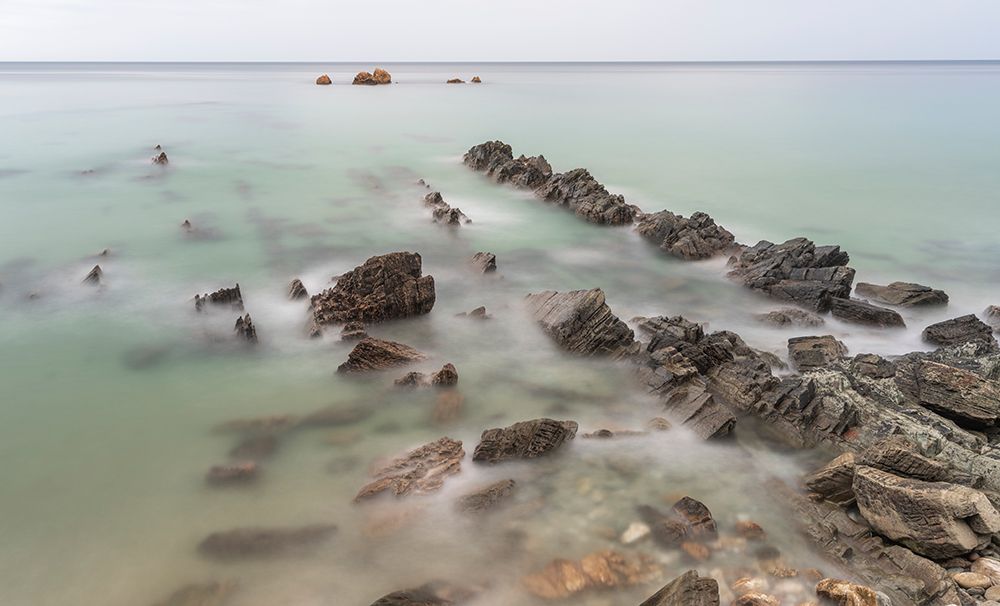 Spain, Playa de Aguilar. Rock formations on ocean shore. art print by Jaynes Gallery for $57.95 CAD