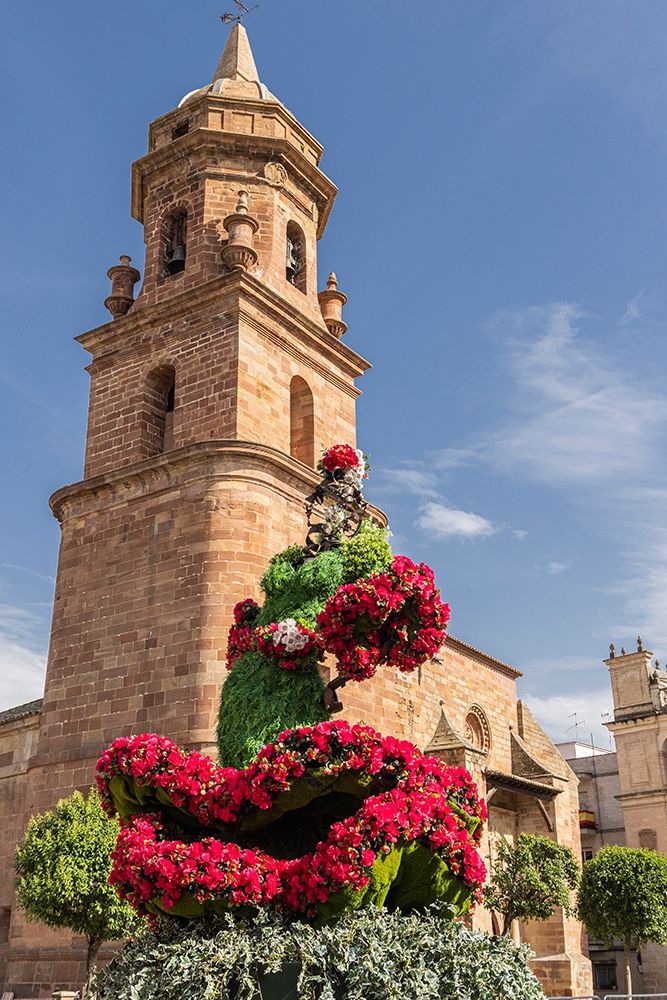 Andujar, Jaen Province, Andalusia, Spain. Red flowers and the bell tower of the San Miguel Church. art print by Emily M. Wilson for $57.95 CAD