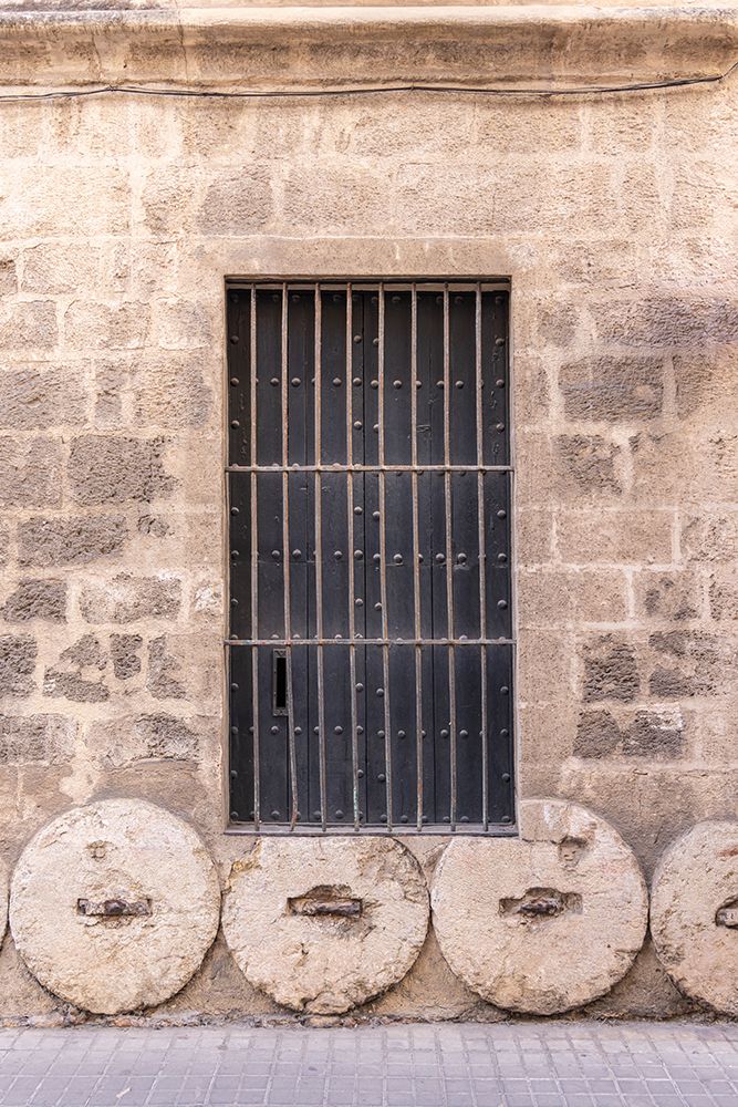 Casco Antiguo, Seville, Andalusia, Spain. Stone wheels being used in the foundation of a building. art print by Emily M. Wilson for $57.95 CAD