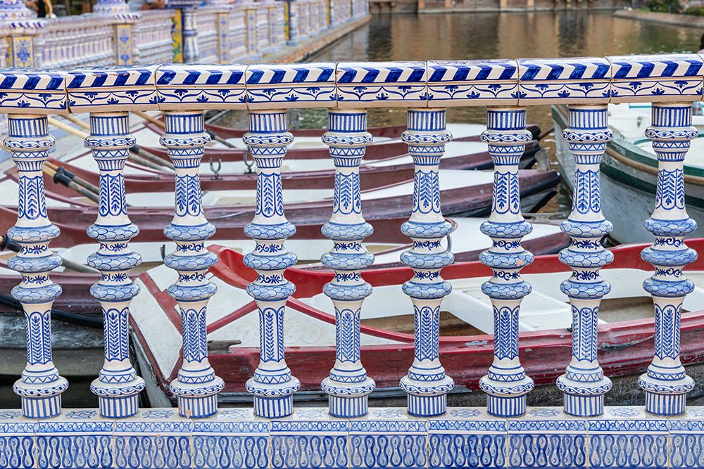 Casco Antiguo, Seville, Andalusia, Spain. Rowboats behind a ceramic banister at the canal. art print by Emily M. Wilson for $57.95 CAD