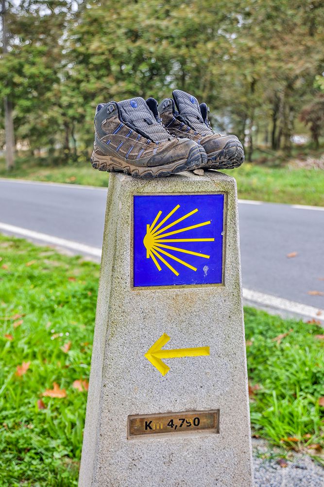 Spain-Galicia Distance marker on the Camino de Santiago with a pair of well worn shoes art print by Hollice Looney for $57.95 CAD
