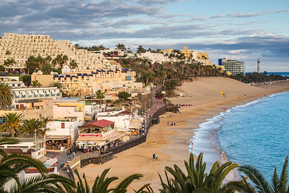Canary Islands-Fuerteventura Island-Morro Jable-high angle view of Playa de la Cebada beach-sunset art print by Walter Bibikow for $57.95 CAD