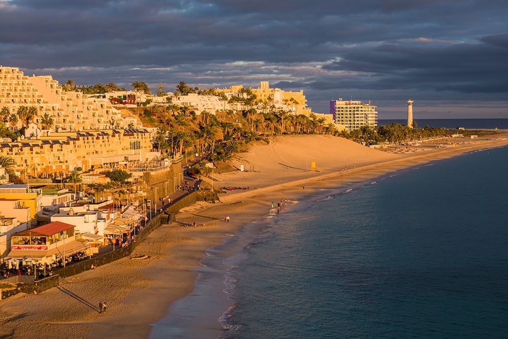 Canary Islands-Fuerteventura Island-Morro Jable-high angle view of Playa de la Cebada beach-sunset art print by Walter Bibikow for $57.95 CAD