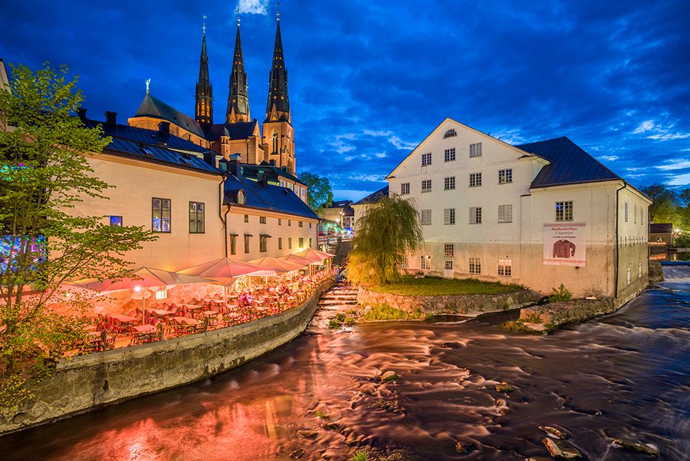 Sweden-Central Sweden-Uppsala-Domkyrka Cathedral with riverfront cafe-dusk art print by Walter Bibikow for $57.95 CAD