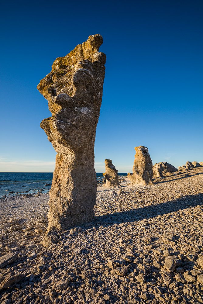 Sweden-Faro Island-Langhammars Area-Langhammar coastal limestone rauk rock-sunset art print by Walter Bibikow for $57.95 CAD