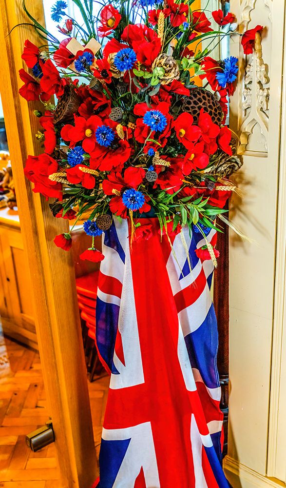 Colorful D-Day memorial flowers poppies, UK Flag, St. Saviours Church, Dartmouth, Devon, England. art print by William Perry for $57.95 CAD