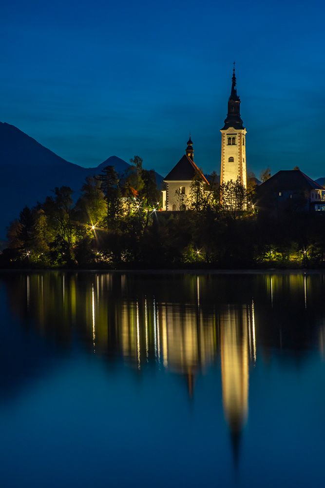 Slovenia, Lake Bled. Sunset lighting reflects in lake. art print by Jaynes Gallery for $57.95 CAD